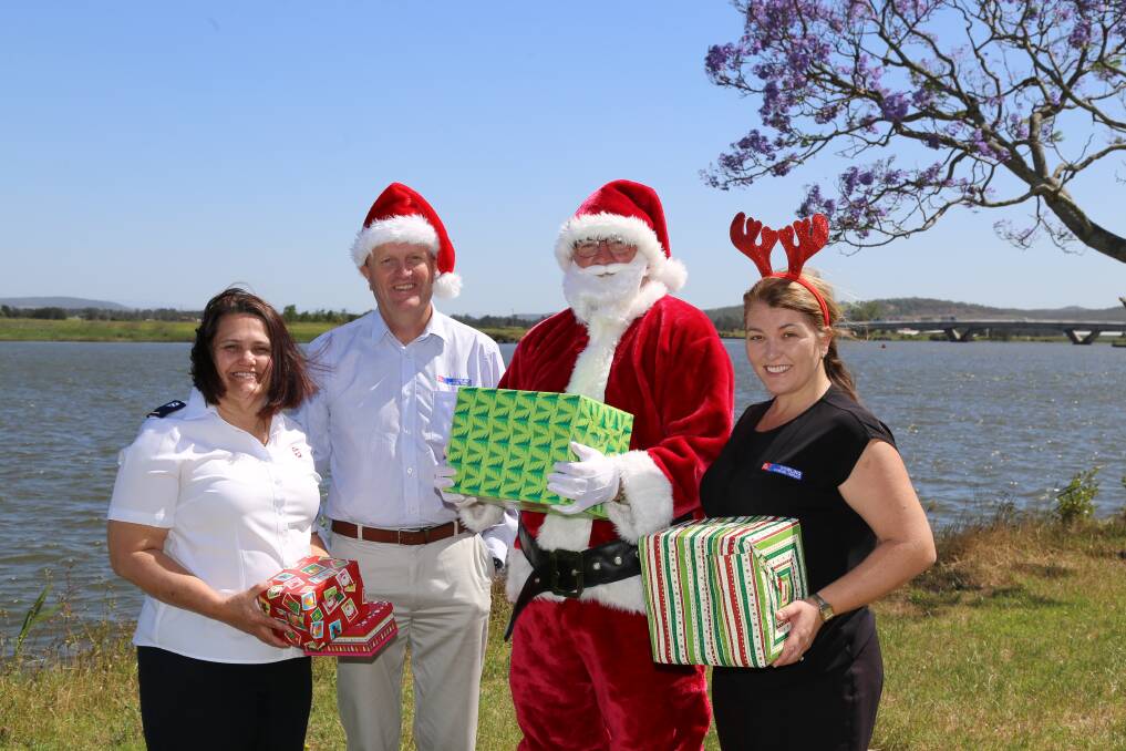 HO HO HO: Salvation Army auxiliary lieutenant Tracy Iles, Dowling Raymond Terrace licensee Gregg Bates, Santa and Michelle Bink from Dowling. Picture: Ellie-Marie Watts