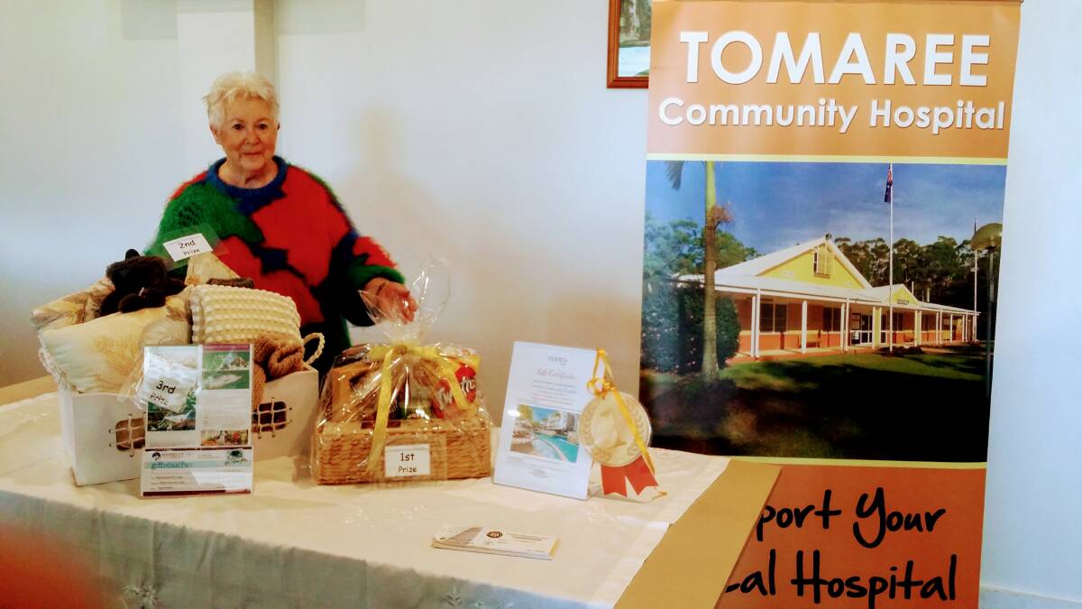 Tomaree Hospital Auxiliary member Maggie McNutt with the winter raffle prizes.