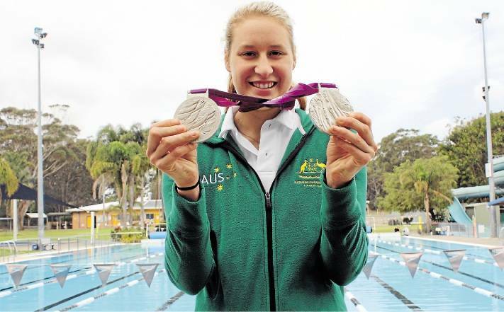 A 17-year-old Taylor Corry at Tomaree Aquatic Centre, Nelson Bay with her two silver medals won at the 2012 London Paralympics. 