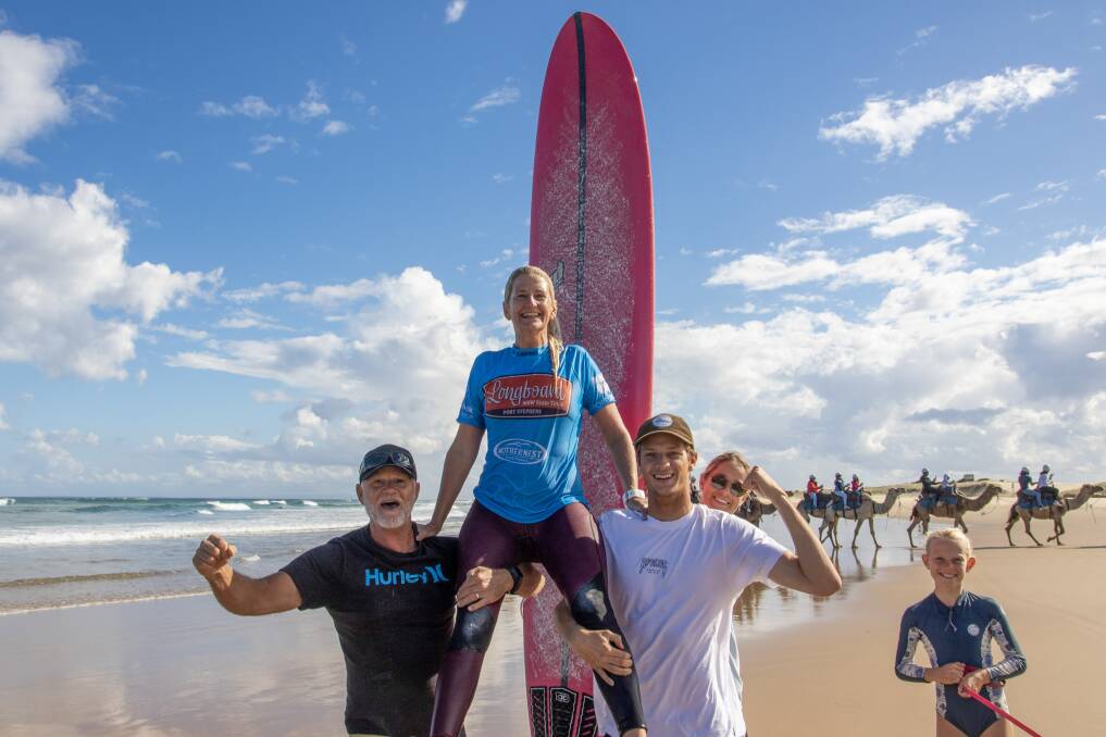 CHAMPION: Suellen Goyne hoisted up by her family after winning a 2021 NSW Longboard State Title. Pictures: Josh Brown/Surfing NSW