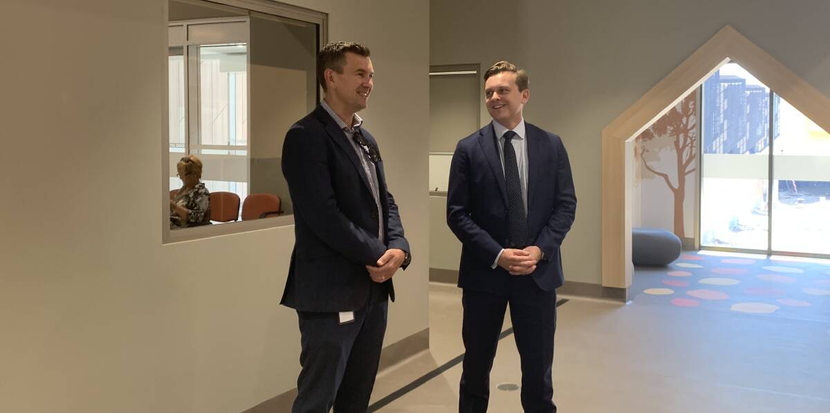 NOW OPEN: Jonathan Holt, general manager of community and aged care services at Hunter New England Health, greater Newcastle sector, with Taylor Martin MLC at the Port Stephens HealthOne this week. 