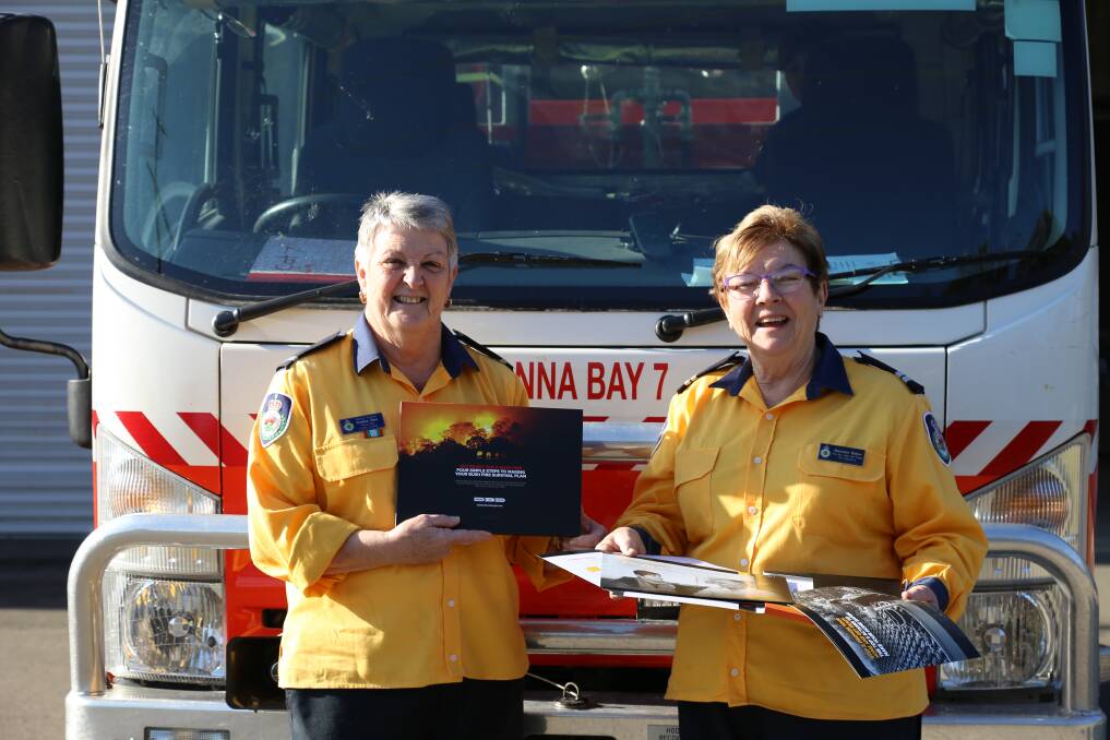 DEDICATED: Anna Bay Rural Fire Brigade deputy captain Kristine Glen with firefighter Maureen Blazer. The pair hold a RFS bushfire survival plan. 