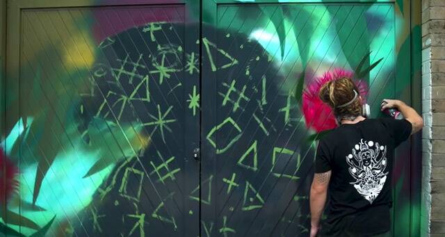 VIBRANT: Artist Jordan Lucky working on a public art piece in Nelson Bay. Picture: Supplied
