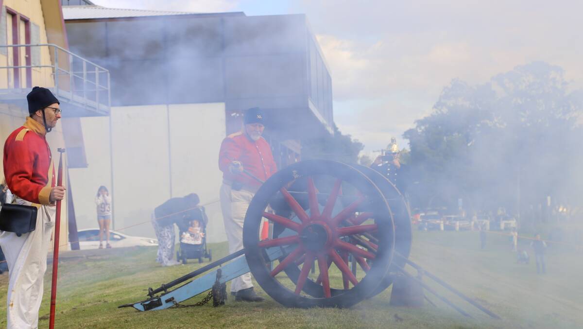 The 40th Regiment of Foot firing a cannon on the Raymond Terrace riverfront on Saturday for the Step Back Into King Street Heritage Festival. 