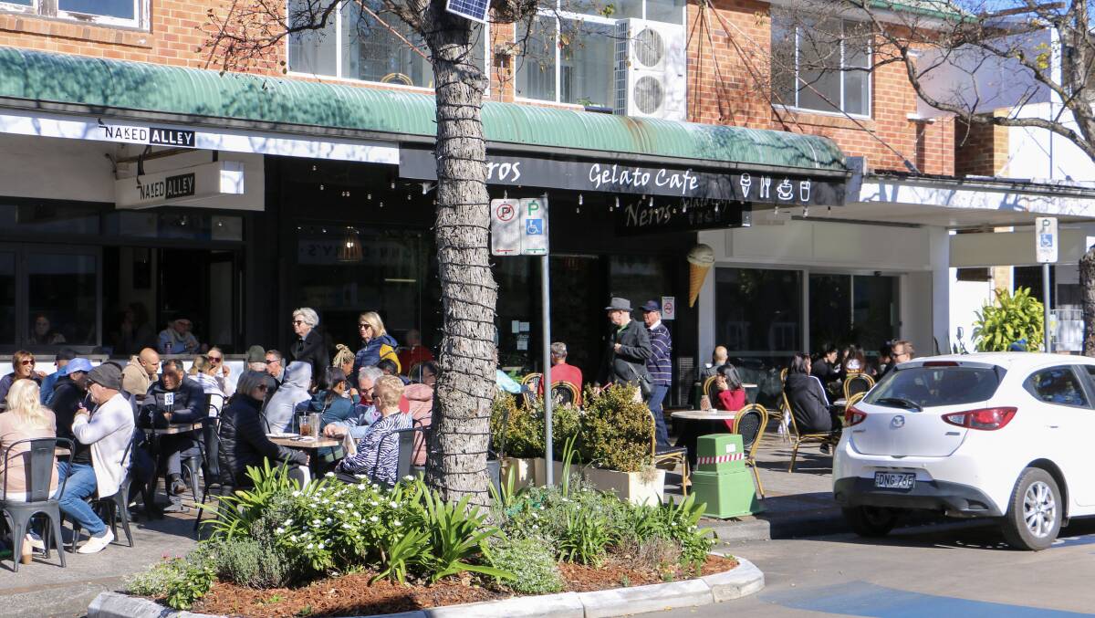 Diners at cafes in Magnus Street, Nelson Bay on Monday morning.