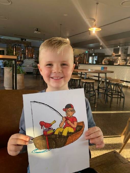 Max Findley holding his competition-winning drawing of John 'Stinker' Clarke's boat, Stinkpot. 