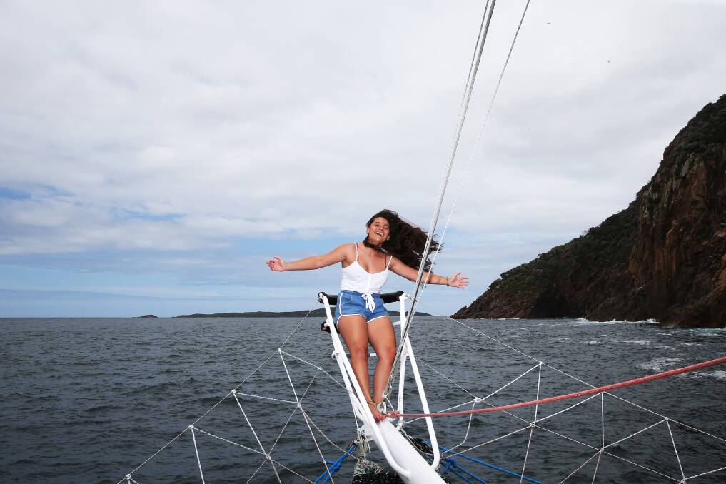 HOLIDAY IN PARADISE: Megan Watt on the bow of a cruise boat outside the Port Stephens heads. The Port is bracing for a bumper Christmas tourism season despite a new COVID outbreak. Picture: Peter Lorimer