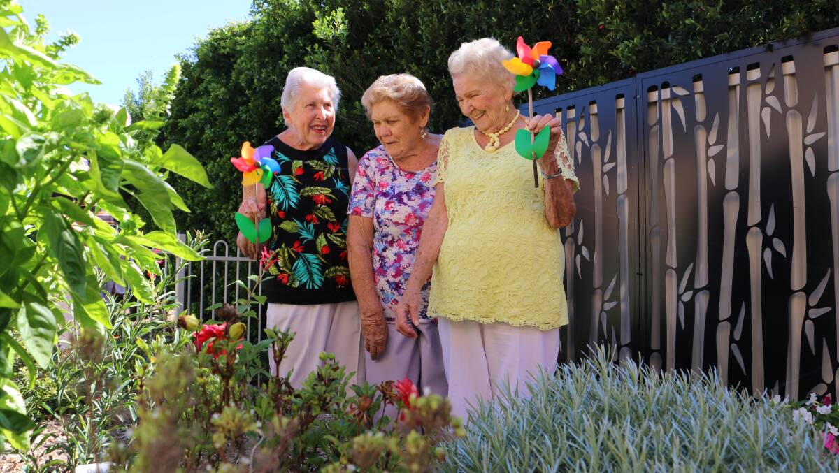 ALL SMILES: Fingal Haven Craft Group's long-time member Greta Clark, vice president Margaret Francis and new recruit Kate Triscott in the Bill King sensory garden. Picture: Ellie-Marie Watts