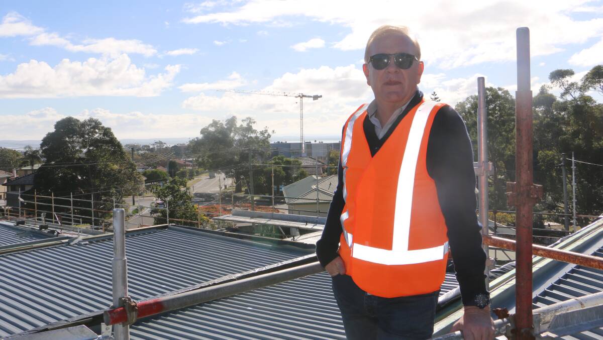 Developer Rod Salmon atop his Talmora development in Nelson Bay with the Ascent site crane in the background.