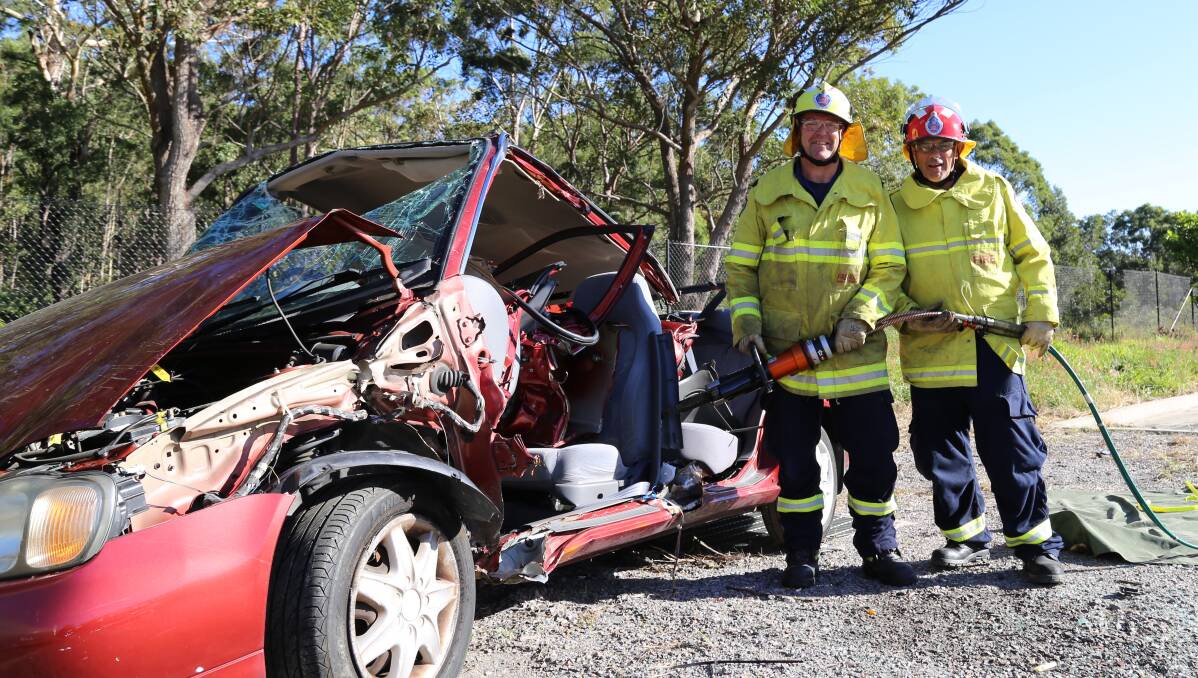 Salamander Bay Fire Station firefighter Simon Chappell and captain Malcom Smith with hydraulic tools used in vehicle crash rescues. The station will be demonstrating how it cuts up cars for rescues during the open day on Saturday. Picture: Ellie-Marie Watts