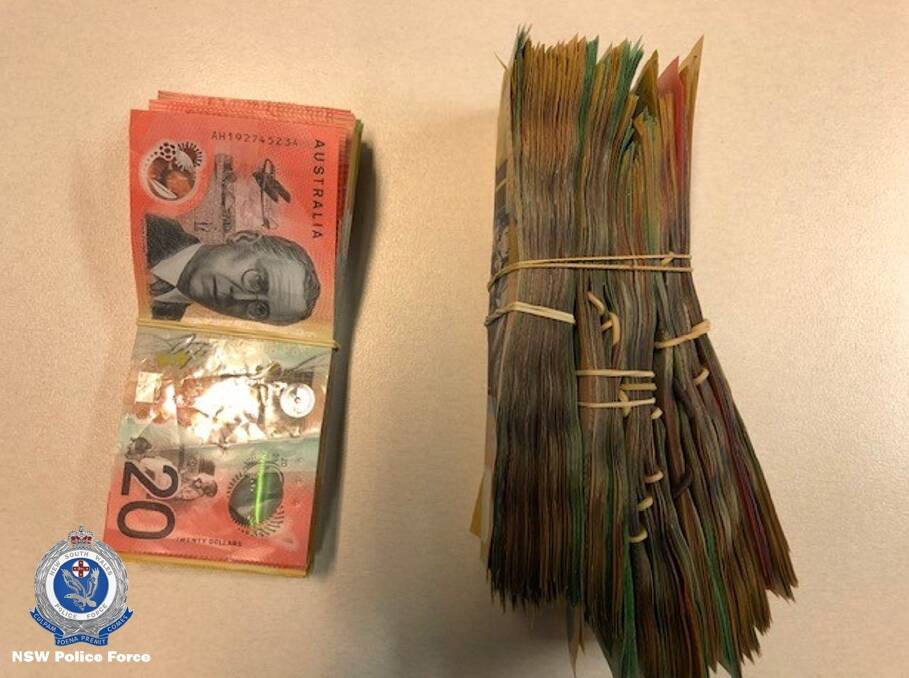 COURT: Cash allegedly found by police in a bag that was dumped in the yard of a Raymond Terrace home during a pursuit on Saturday night. Picture: NSW Police