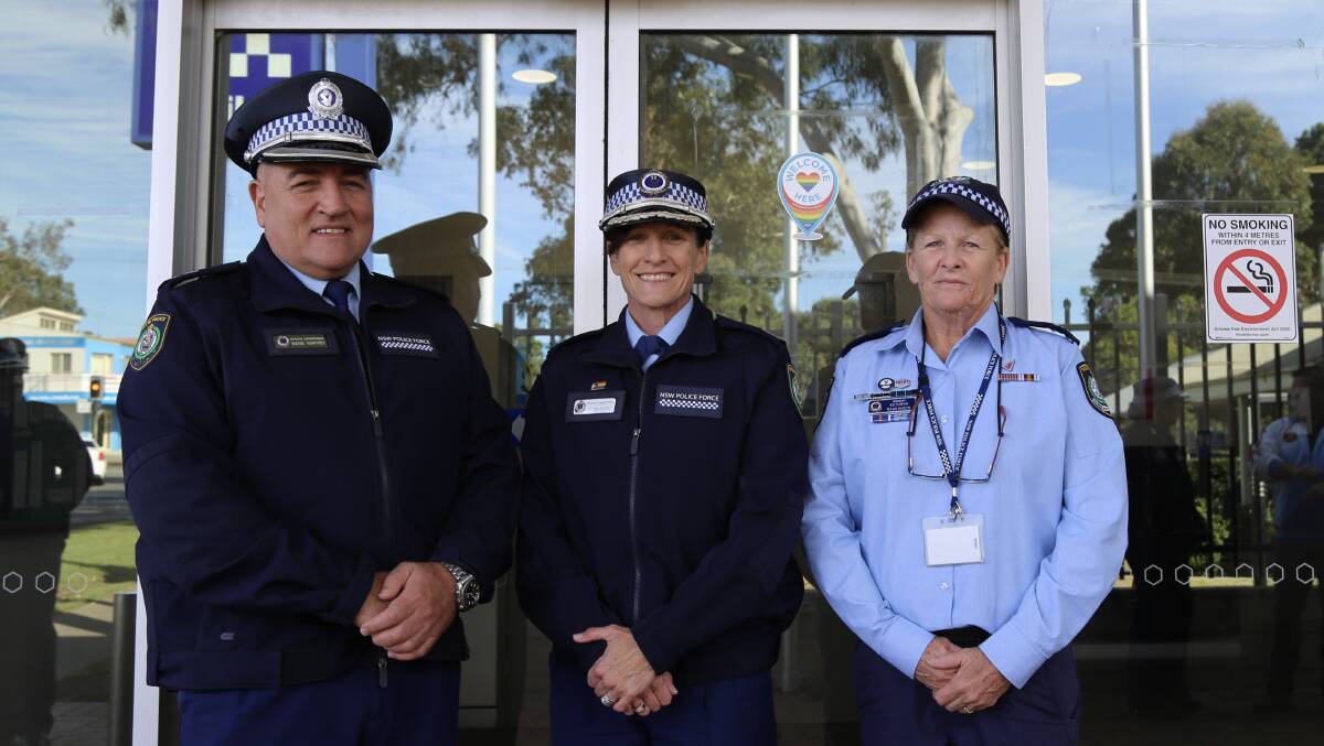 Superintendent Wayne Humphrey, Assistant Commissioner Gelina Talbot and Sergeant Kathryn Rawlinson with the Welcome Here sticker on the Raymond Terrace Police Station doors.