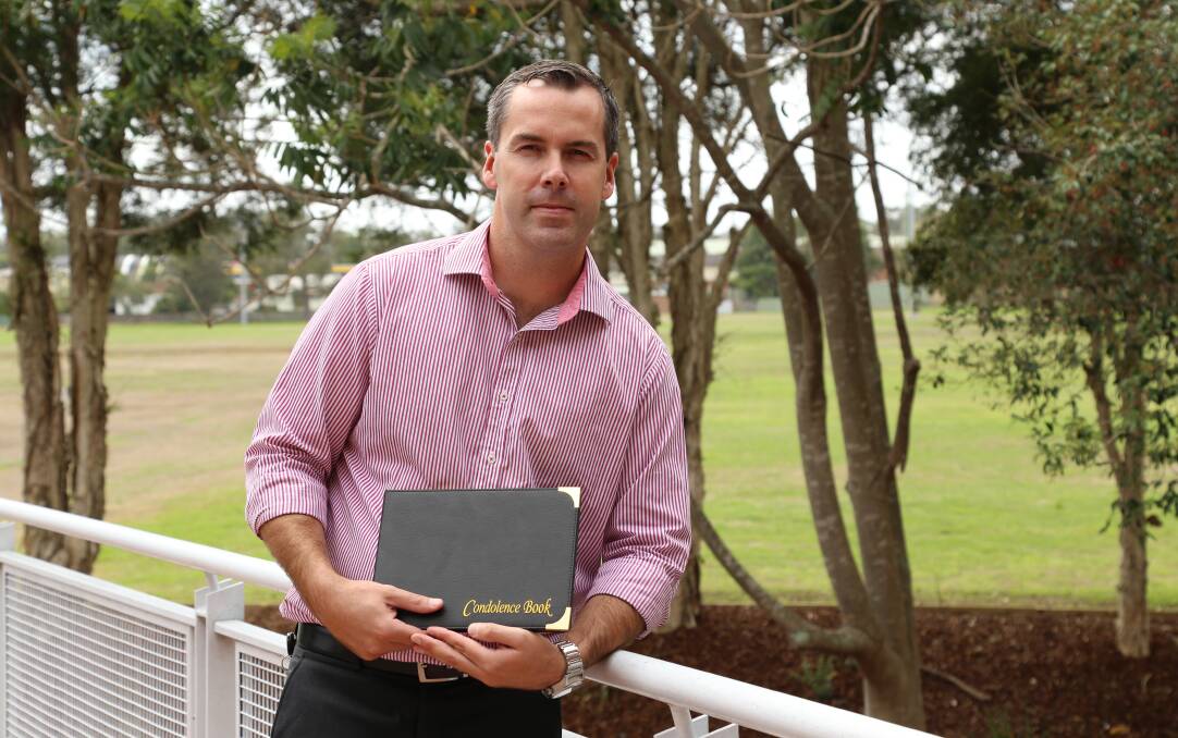 SYMPATHIES: Port Stephens Mayor Ryan Palmer with one of the condolence books that will be available at libraries and the council administration building for residents to sign. Picture: Ellie-Marie Watts