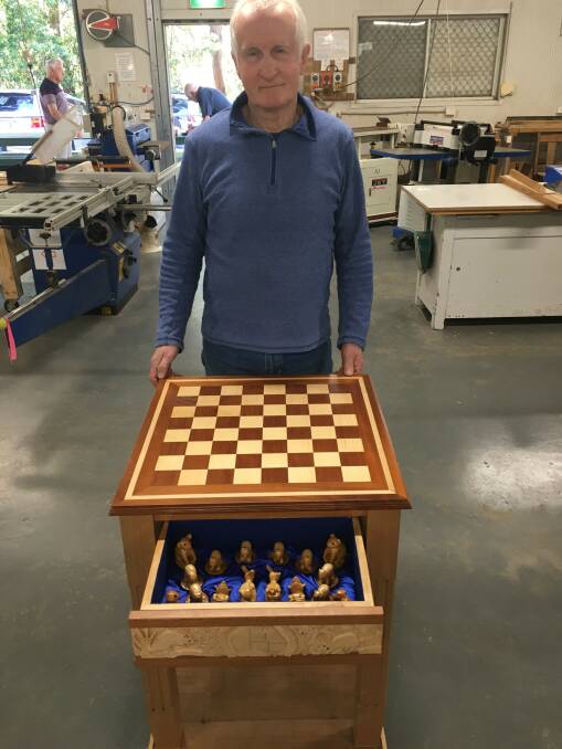 PROJECT COMPLETE: Port Stephens Community Woodworkers member Chris Sturt with the Australian wildlife-themed chess set that is being raffled off by the club.
