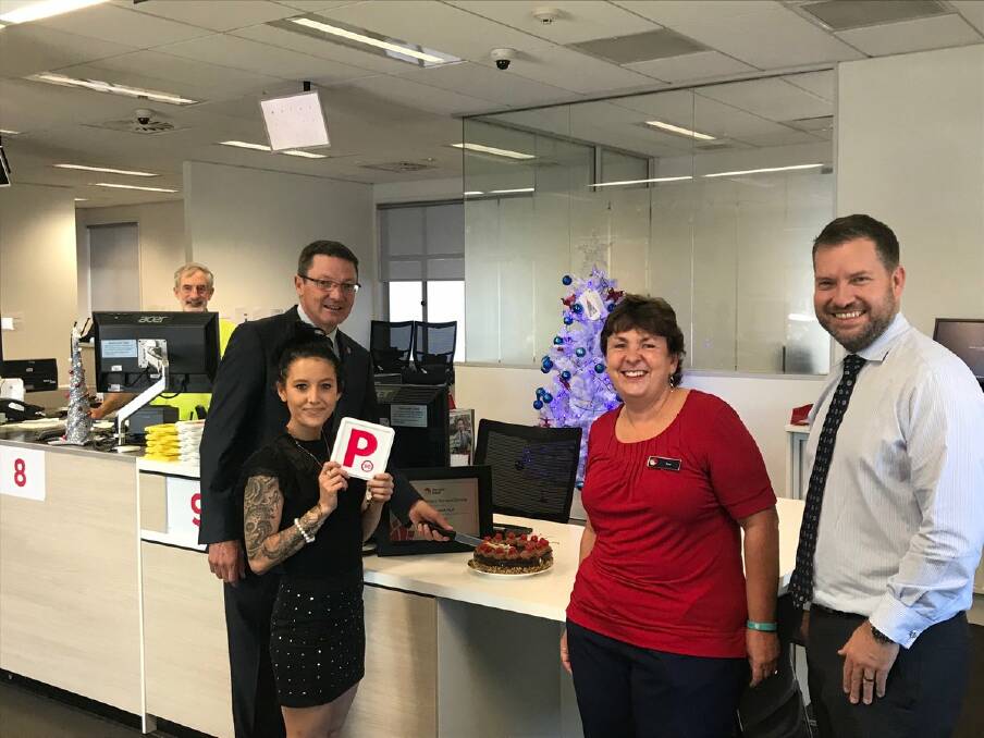 OFFICIALLY OPEN: Scot MacDonald MLC with service centre manager Sue Horsfall (in red), Service NSW CEO Damon Rees and a customer.