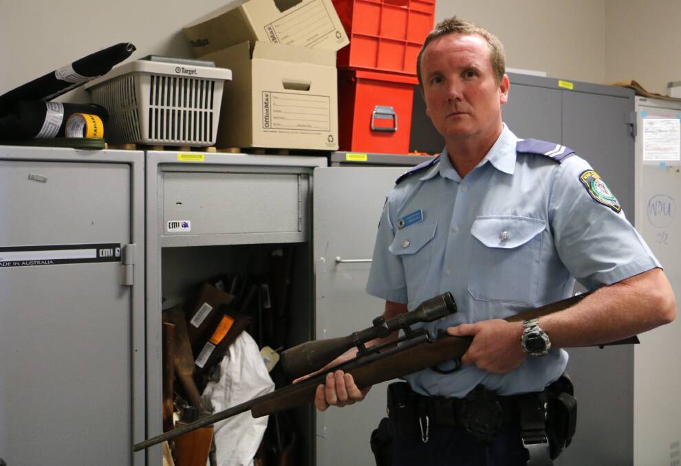 SURRENDER: Senior Constable Thomas Marshall holding a rifle that is in the custody of Port Stephens police. Picture: Ellie-Marie Watts