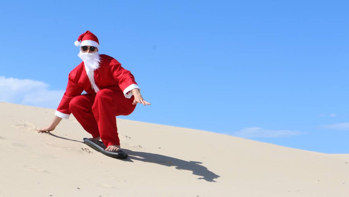 SAND'S UP: Santa took some time out before Christmas this week to hit the dunes at Anna Bay. Picture: Ellie-Marie Watts