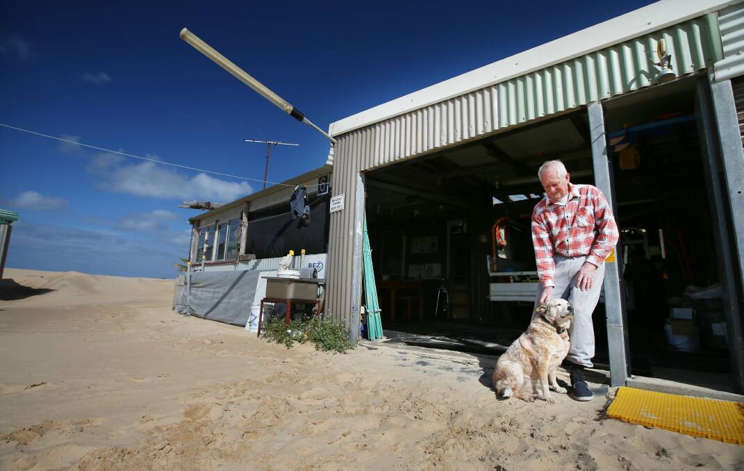 Tin City hut owner Alwyn Garland with his dog Sandy in 2013.