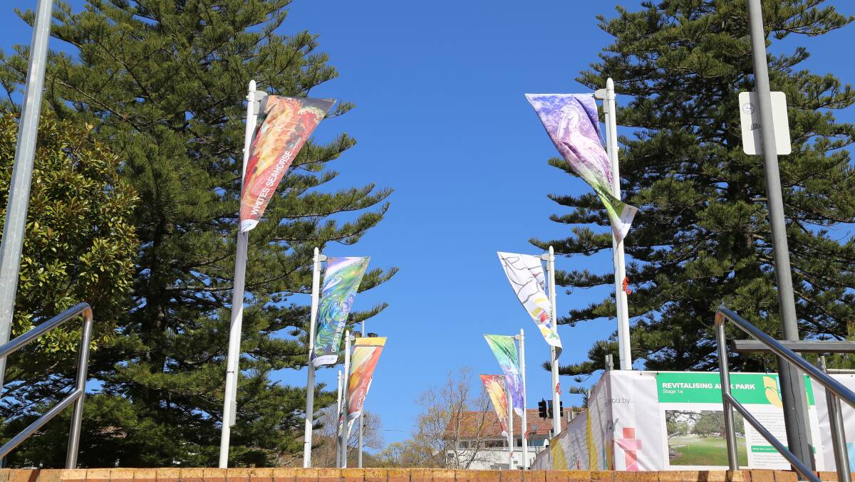 The Walk Of Art street flags in Apex Park.