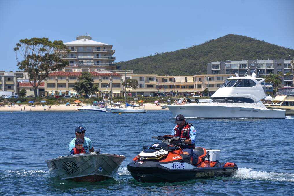 BLITZ: A NSW Maritime boating safety officer checks the licence and registration of a boat operator in Shoal Bay in October 2019. Picture: Max McKinney