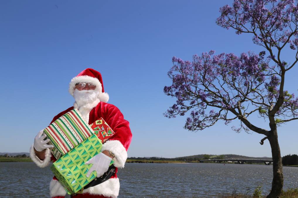 Santa with some gifts down along the Hunter River at Raymond Terrace. Picture: Ellie-Marie Watts