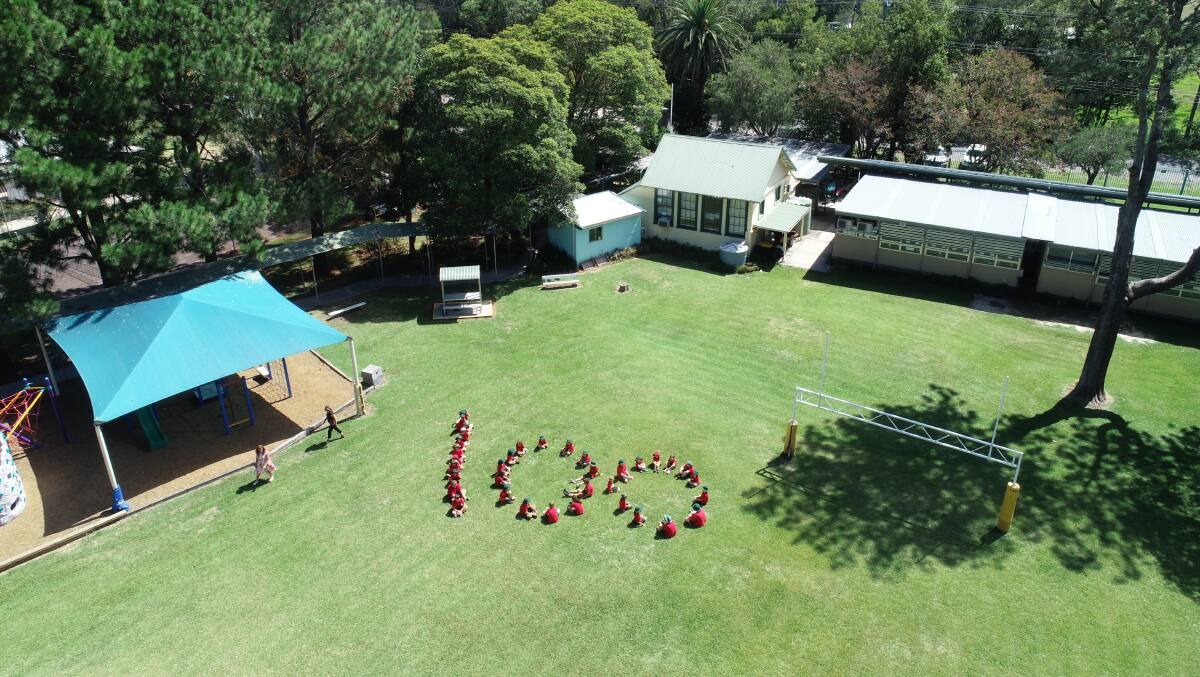 The school's small student body mark out 100 for the centenary. 