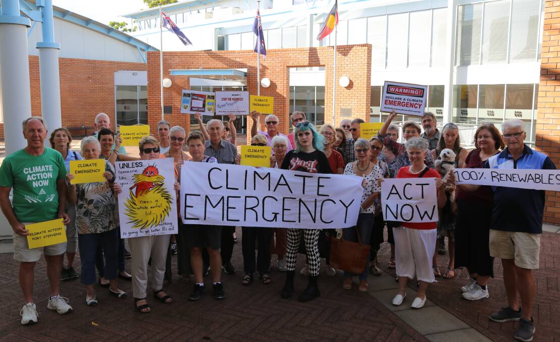 CALL TO ACTION: Climate change protesters gathered outside the Port Stephens Council administration building in Raymond Terrace on Tuesday night before the second council meeting of the year.