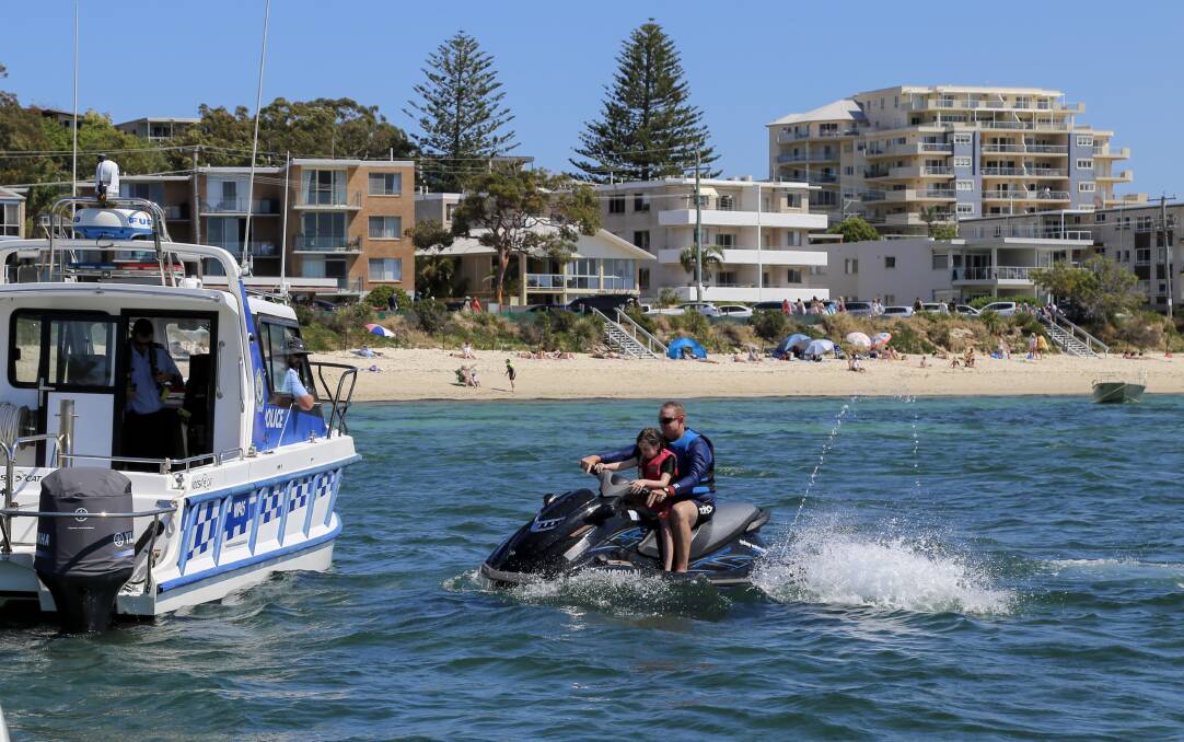 HAVE FUN: Water police conducting a licence check at Shoal Bay during an education and safety operation in October. Picture: Ellie-Marie Watts