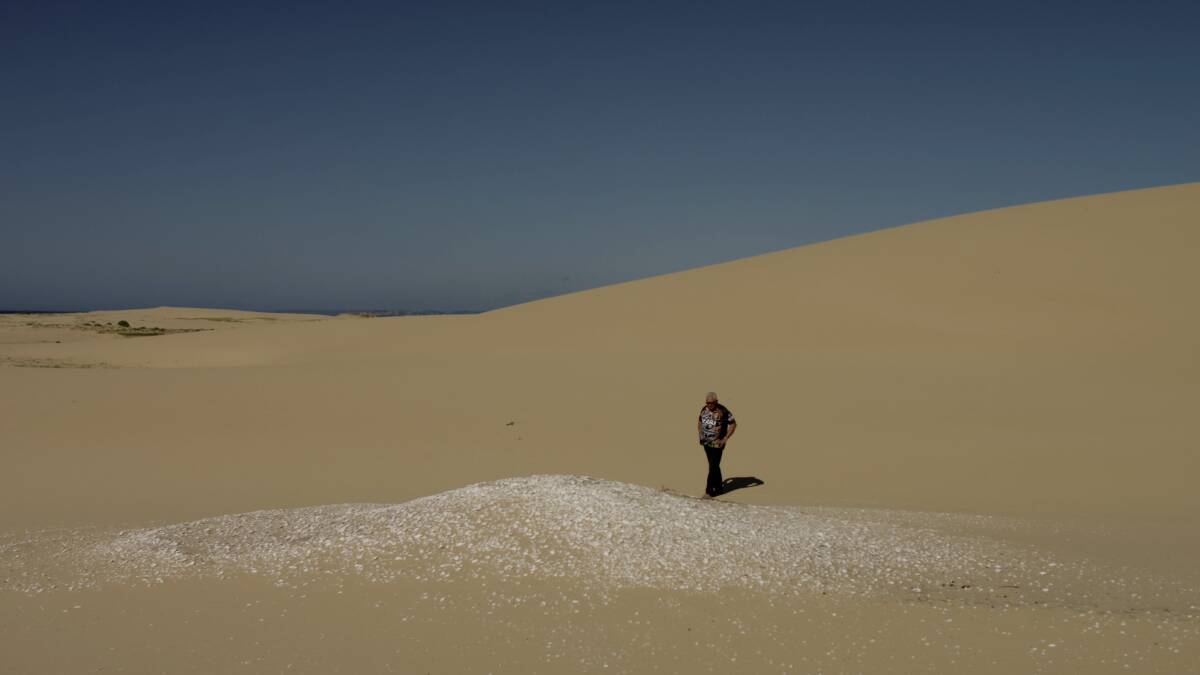 Worimi Elder Uncle Graeme Russell walking the conservation lands during filming of a dreaming video in which he shares the tale on how the sand dunes came into being. 