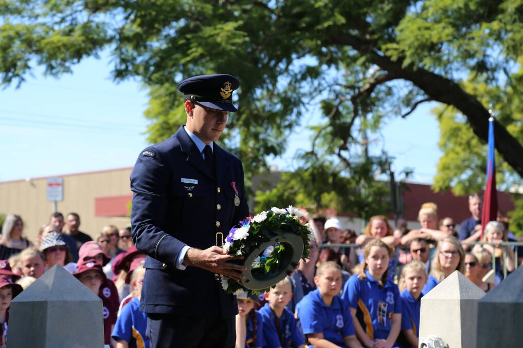 The RAAF's Matthew Bell laying a wreath during Raymond Terrace's Anzac Day service. Picture: Ellie-Marie Watts