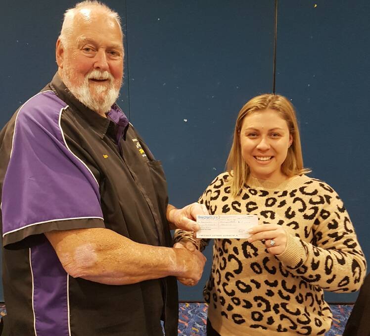 GIVING: Ian Jones, president of the Tilligerry Auto Club, presented this year's motorama proceeds to Kiera Wray, the fundraising officer at John Hunter Children's Hospital.