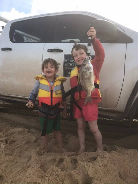 WHAT A CATCH: Scone fishing champions Will, 3, and Jack Roberts, 5, with a cracker bream at Stockton Beach.