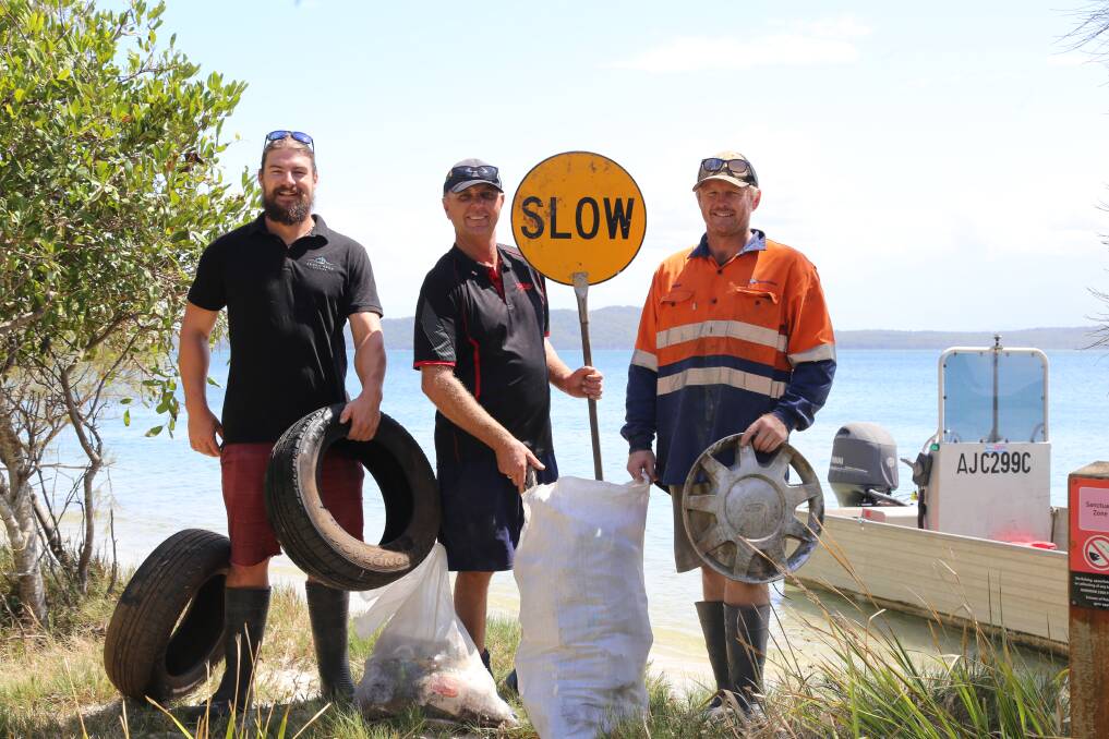 RUBBISH HAUL: Rob Redmayne from Seven Seas Oysters, Stephen Cole from Cole Bros Oysters and Hayden Sharpe from Sweet Water Oysters with rubbish collected from Salamander Bay on February 22. Picture: Ellie-Marie Watts