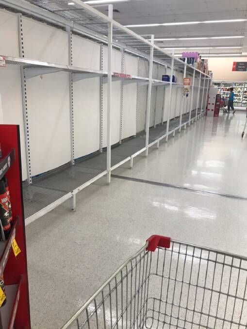 BUY UP: Shelves have been wiped of toilet paper at Coles Salamander Bay.