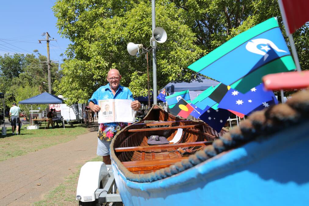 Mark Miller and the canoe made by former councillor Geoff Dingle on display in Raymond Terrace on Australia Day.