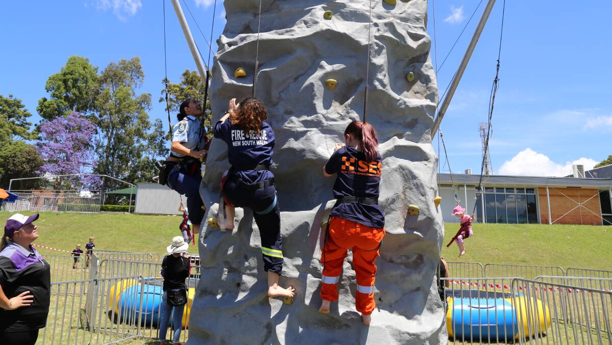 A rock wall climb challenge between Senior Constable Charlie Maybury (Port Stephens police), Isabel Rios (Fire and Rescue Raymond Terrace) and Sahra Challinor (Port Stephens SES). Senior Constable Maybury brought the win home for police.
