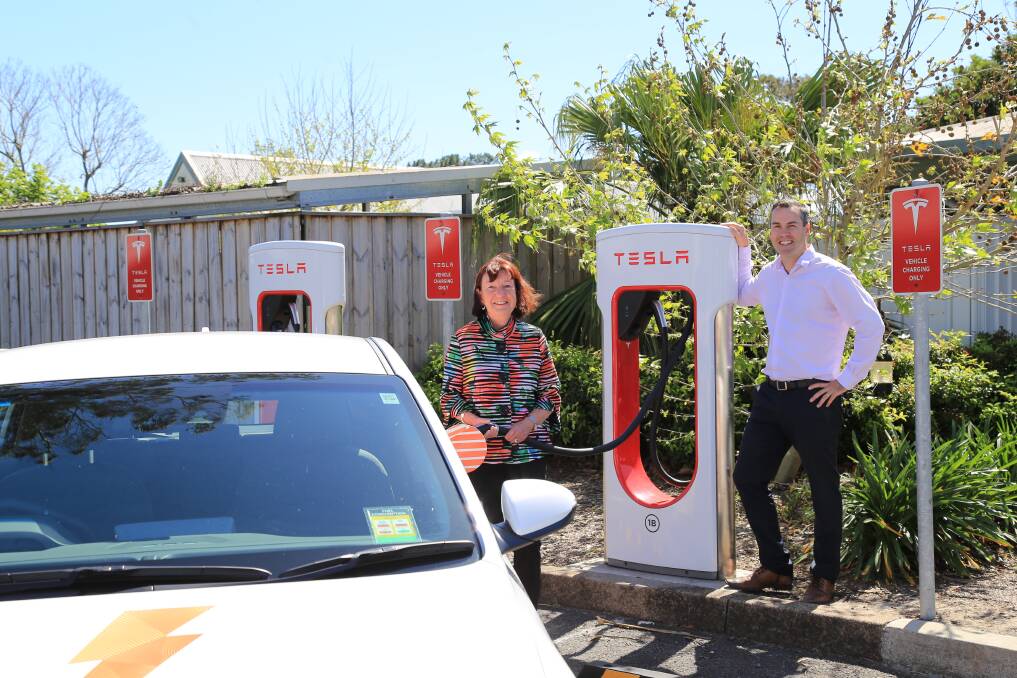 GREEN: Lake Macquarie mayor Kay Fraser with Port Stephens mayor Ryan Palmer at the Tesla electric vehicle charging station in Heatherbrae. The two councils have joined the Cities Power Partnership program. Picture: Ellie-Marie Watts