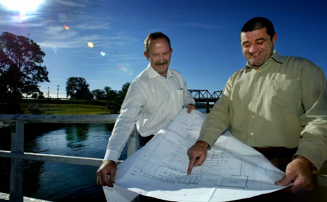 LOOK BACK TO 2014: Karuah RSL secretary manager Steve Pell and director Paul Gallagher at Karuah with plans for the RSL club's upgrade in 2004.