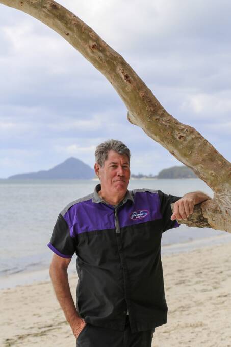 USE YOUR KIT: Port Stephens photographer Stephen Keating at Bagnalls Beach. Mr Keating, who has battled bowel cancer, is encouraging residents who receive a bowel cancer home testing kit in the mail to use it. Picture: Ellie-Marie Watts