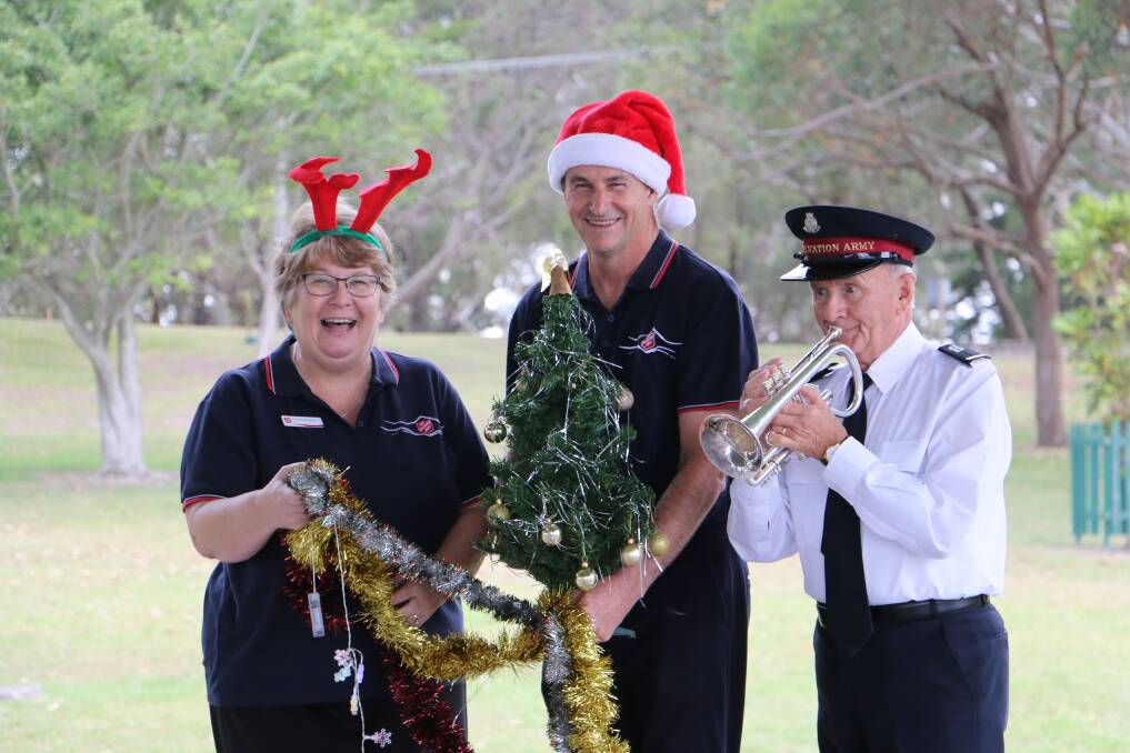 Salvation Army envoys Sandra and Howard Koutnik with Alex Gardiner at the Fly Point park where Carols by the Bay will be staged on December 10.
