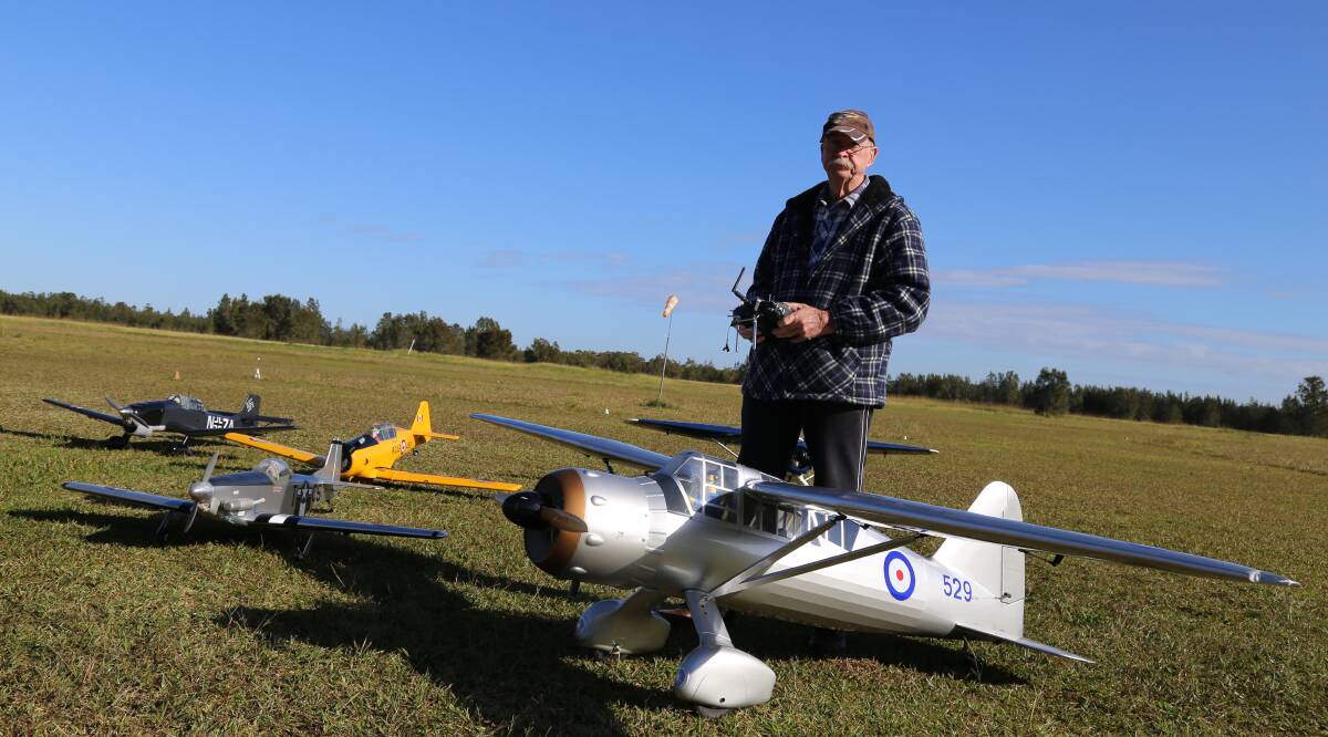 Peter Sharp with one of his model planes at the Bobs Farm air field. Mr Sharp is a founding member of the Port Stephens Model Aircraft Club. Picture: Ellie-Marie Watts