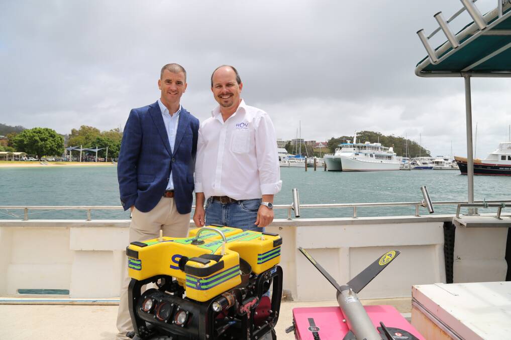 NEW SEARCH: Ed Korber, managing director of Subsea, and Michael Porritt, director of ROV Innovations, with one of the remotely operated underwater vehicles that will be used to locate submerged shipping containers from the YM Efficiency. Picture: Ellie-Marie Watts
