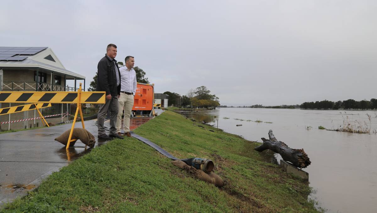 ASSESSMENT: Port Stephens Council's group manager of facilities and services, Greg Kable, surveying the Hunter River at Raymond Terrace with Mayor Ryan Palmer. Behind them is the Bourke Street stormwater pump. Picture: Ellie-Marie Watts