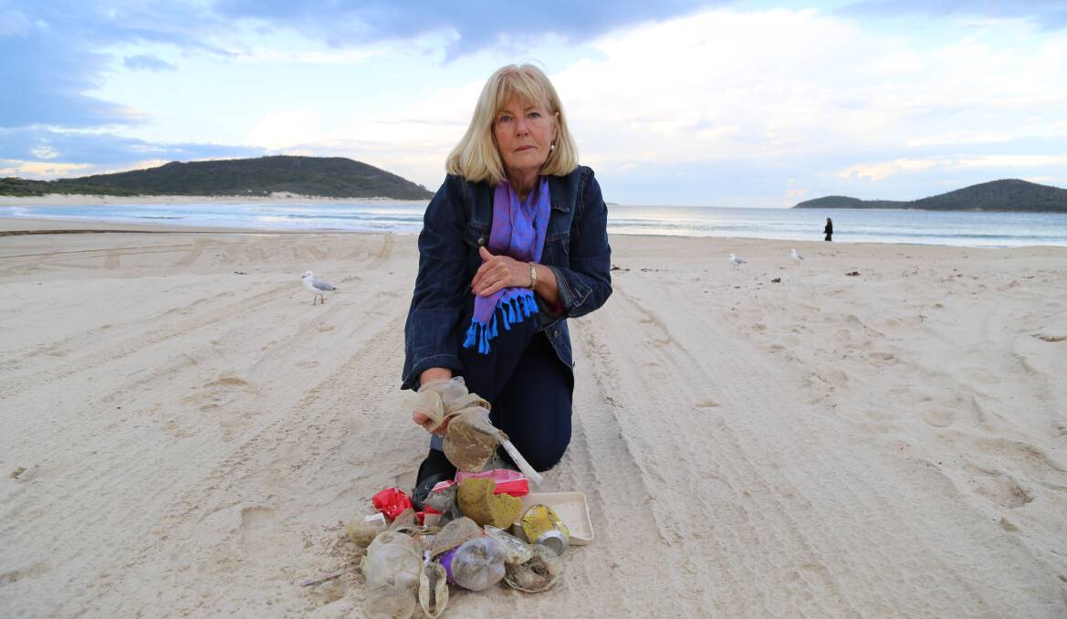Pamela Smith with rubbish she collected from Fingal Bay beach on the first weekend in June - one year after the YM Efficiency container overboard incident. Picture: Ellie-Marie Watts
