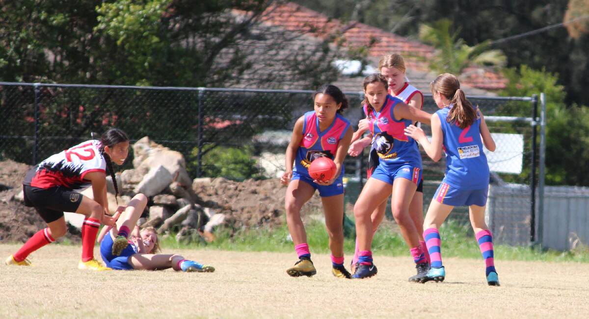 Action from the AFL under 14 girls grand final played at Warners Bay on Sunday.
