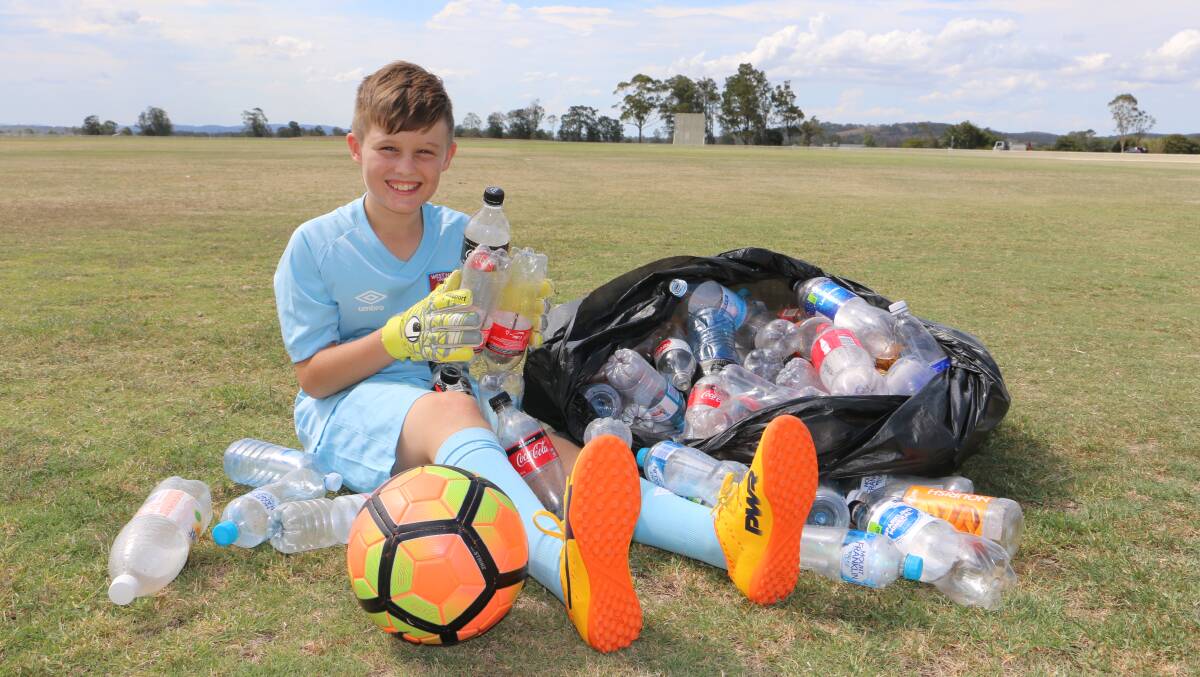 SMART: Xander Oxford, 10, from Raymond Terrace is raising money for a football trip to England using the Return and Earn reverse vending machine scheme. Picture: Ellie-Marie Watts