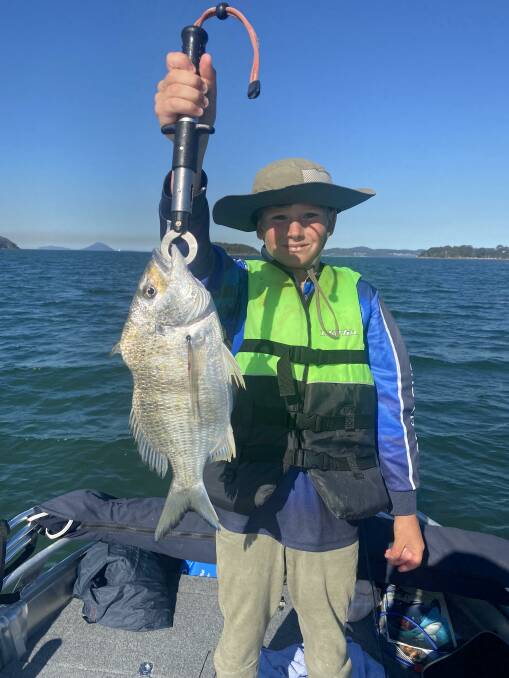 PROUD AS PUNCH: Young Harrison Marklew with a Soldiers Point cracker bream.