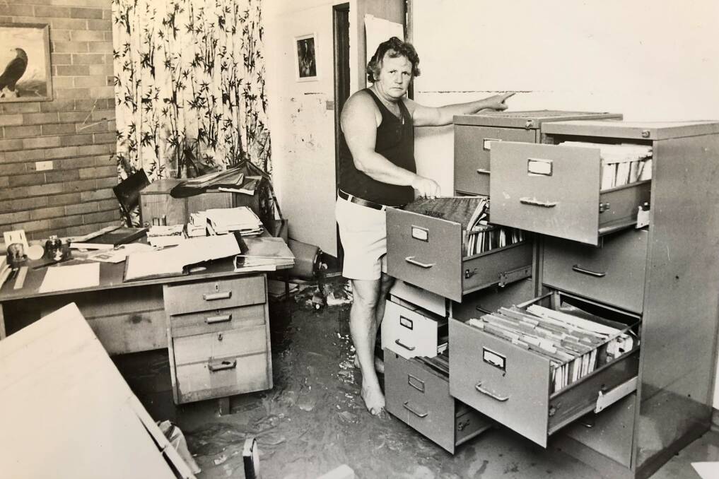 Ted Brown in the office of Nelson Bay Primary School following a flood in the 1980s.