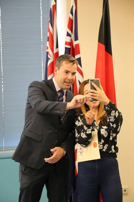 Cr Palmer presented Australian citizenship certificates to 27 people in Raymond Terrace on Monday, September 17. Here he takes a 'selfie' with Piyanuch 'Mod' Silapranimith, who has lived in Australia for 18 years.