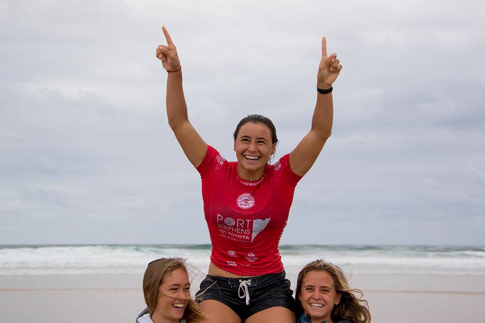 Johanne Defay is lifted up out of the water after winning the 2017 Port Stephens Toyota NSW Pro Women’s QS6000. Picture: Ethan Smith / Surfing NSW